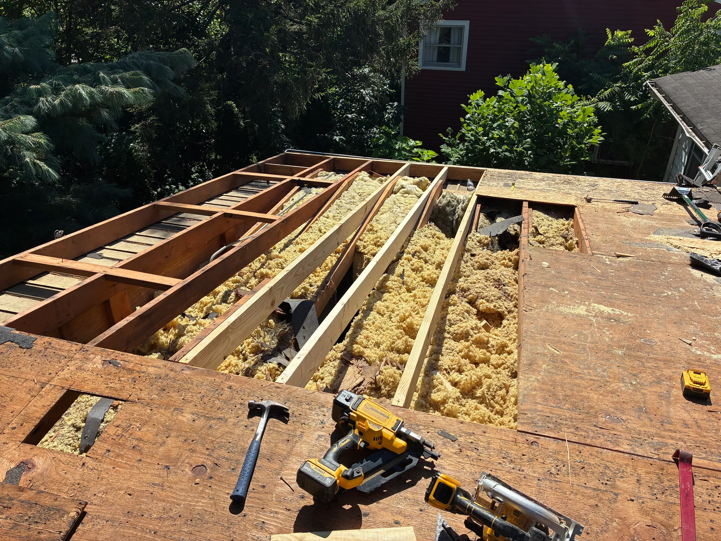 Interior view of completed water damage restoration showing new drywall installation, ceiling repairs, properly installed flooring, and complete reconstruction of damaged areas with color-matched finishes.